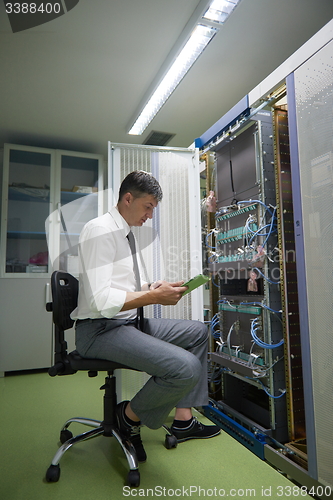 Image of network engineer working in  server room