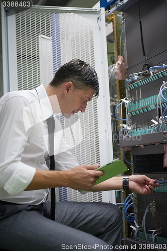 Image of network engineer working in  server room