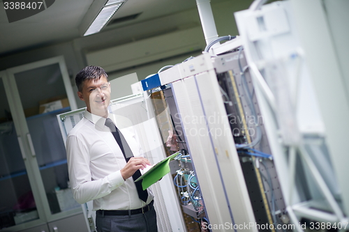 Image of network engineer working in  server room