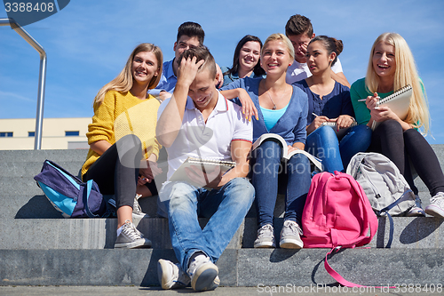 Image of students outside sitting on steps