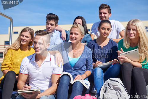 Image of students outside sitting on steps