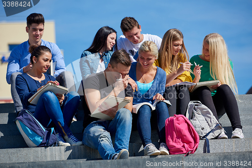 Image of students outside sitting on steps