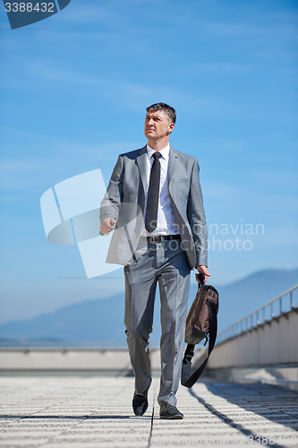 Image of senior  businessman outdoors