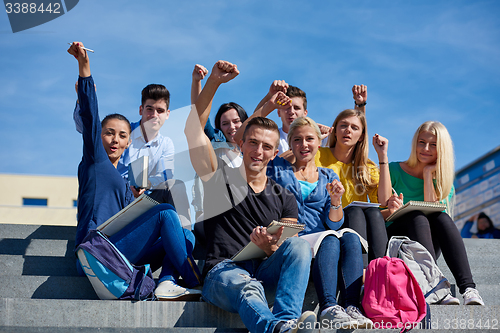 Image of students outside sitting on steps