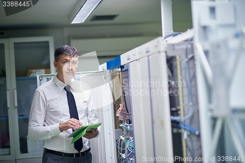 Image of network engineer working in  server room