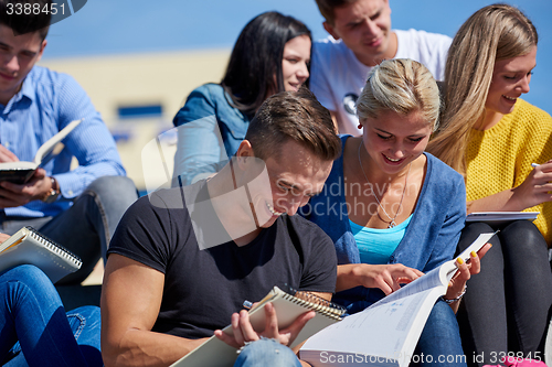 Image of students outside sitting on steps
