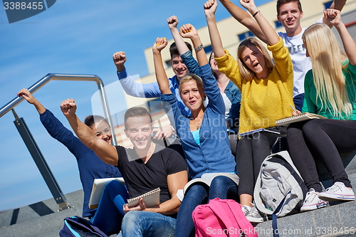 Image of students outside sitting on steps