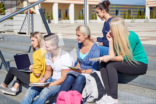 Image of students outside sitting on steps