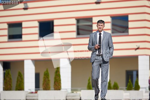 Image of senior  businessman outdoors