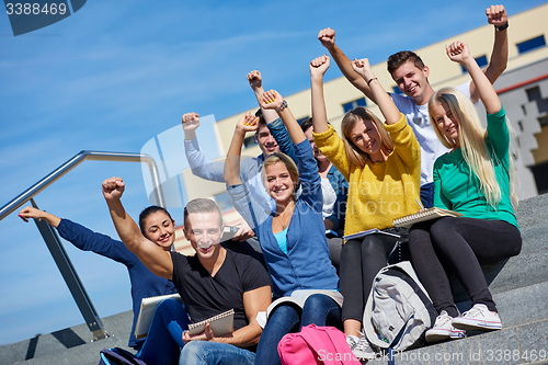 Image of students outside sitting on steps