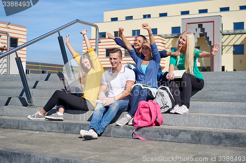 Image of students outside sitting on steps