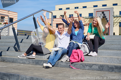 Image of students outside sitting on steps