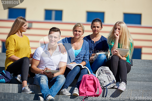 Image of students outside sitting on steps