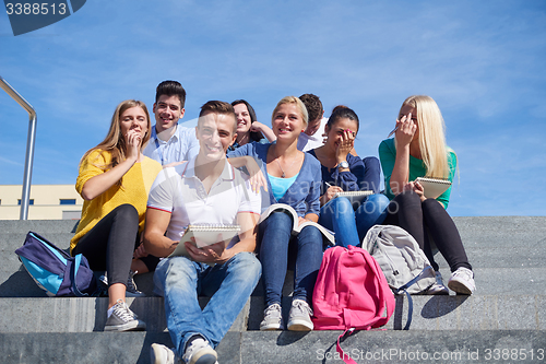 Image of students outside sitting on steps