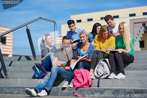 Image of students outside sitting on steps
