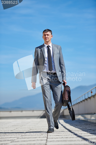 Image of senior  businessman outdoors