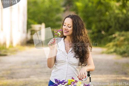 Image of Happy girl with her bicycle