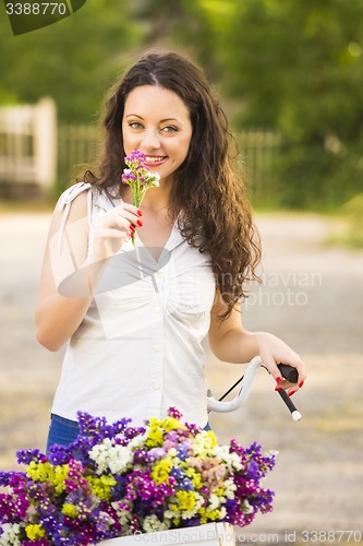 Image of Happy girl with her bicycle