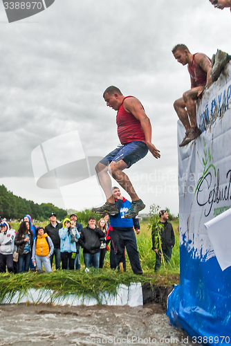 Image of Sportsmen jumps in water. Steel Character. Tyumen