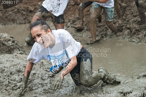 Image of Attractive girl in extrime racing in mud hole