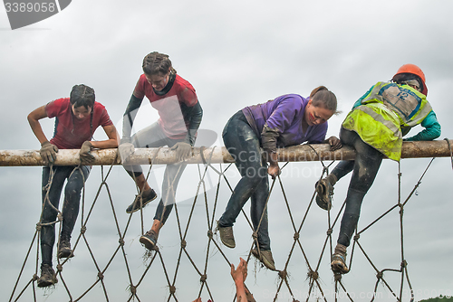 Image of Team storms net wall in extrim race. Tyumen.Russia