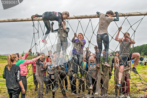 Image of Team storms net wall in extrim race. Tyumen.Russia