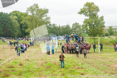 Image of Team storms net wall in extrim race. Tyumen.Russia