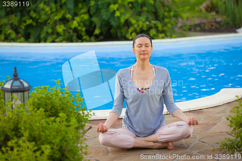 Image of pretty adult woman doing yoga