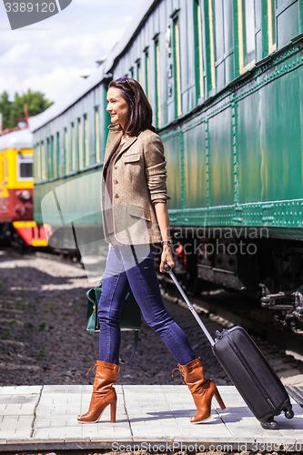 Image of beautiful adult woman with a luggage