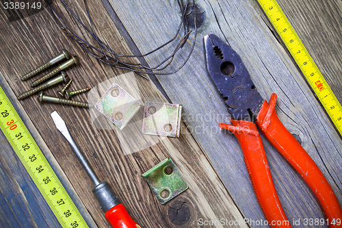 Image of Vintage pliers, screwdriver, screws, wire, angles and roulette