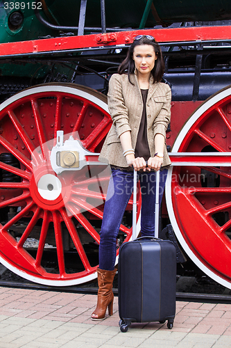 Image of Travel portrait of a beautiful adult woman with luggage