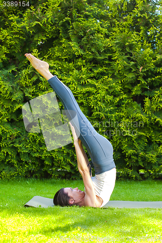 Image of pretty adult woman doing yoga
