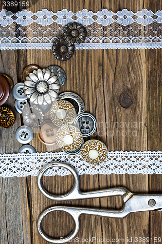 Image of vintage buttons, lace, and a dressmaker scissors