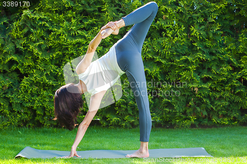 Image of pretty adult woman doing yoga