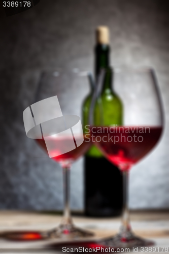 Image of red wine in glass and bottle