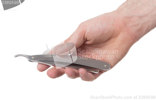 Image of Old straight razor held by one hand