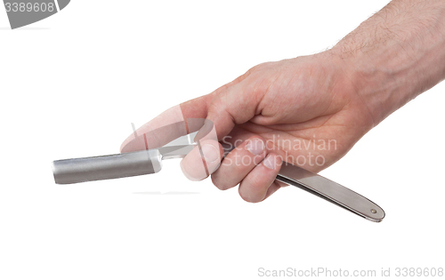 Image of Old straight razor held by one hand