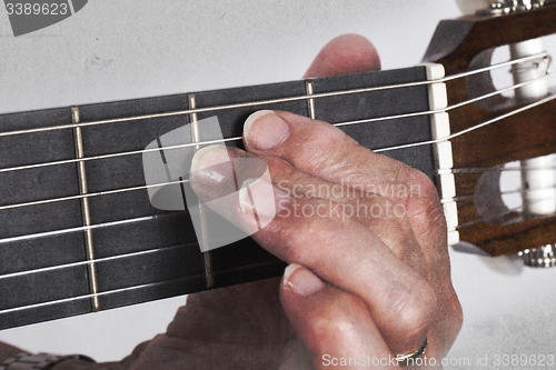 Image of Old hand and guitar isolated