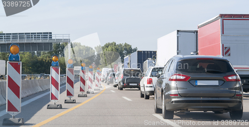 Image of freeway with building lot and traffic jam