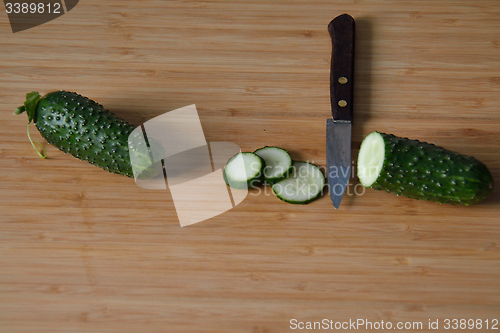 Image of Cucumbers with a knife