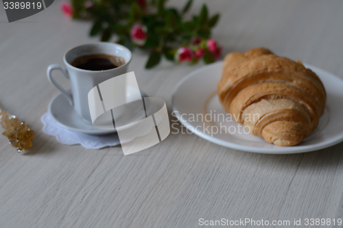 Image of coffee, sugar and a croixant 