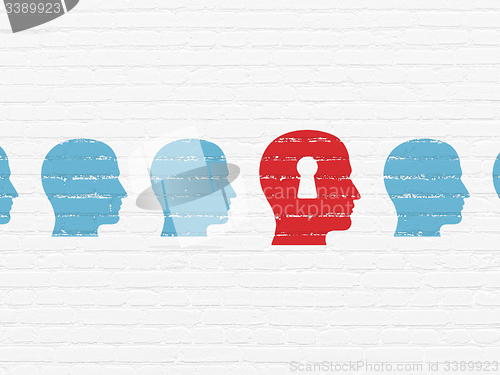 Image of Learning concept: head with keyhole icon on wall background
