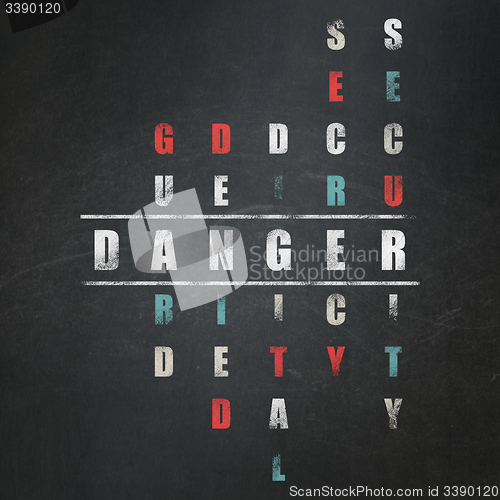 Image of Protection concept: word Danger in solving Crossword Puzzle