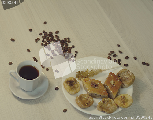 Image of baklava, coffee and dried figs on the table