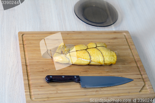 Image of wooden board with a piece of squid