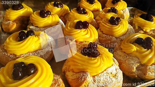 Image of Eclairs with cream and cherry