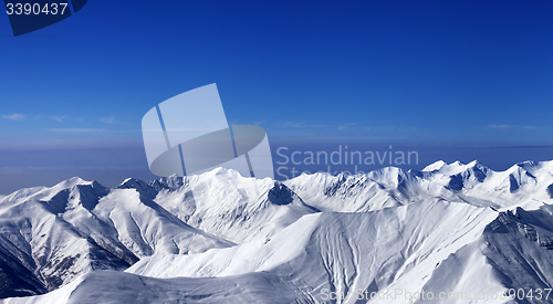 Image of Panoramic view on off-piste slopes and multicolor blue sky at ni