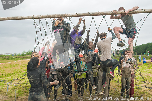 Image of Team storms net wall in extrim race. Tyumen.Russia