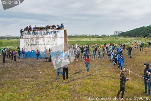 Image of Teams storm big wall in extrim race. Tyumen.Russia