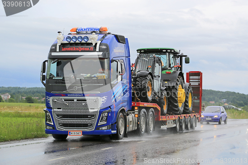 Image of Volvo FH16 Truck Hauls John Deere Machinery